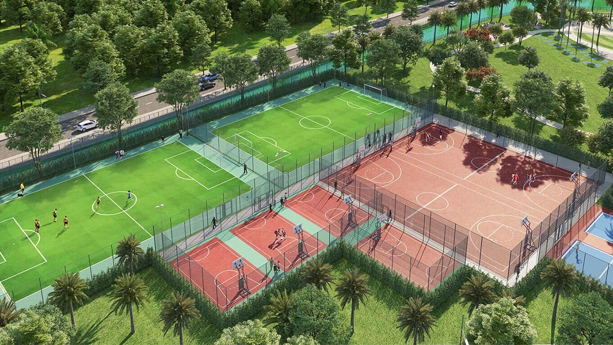 Sân thể thao đa năng với hệ thống sân bóng đá, bóng rổ và tennis hiện đại, được bao quanh bởi mảng xanh thiên nhiên, tạo không gian vận động – giải trí lý tưởng cho cư dân