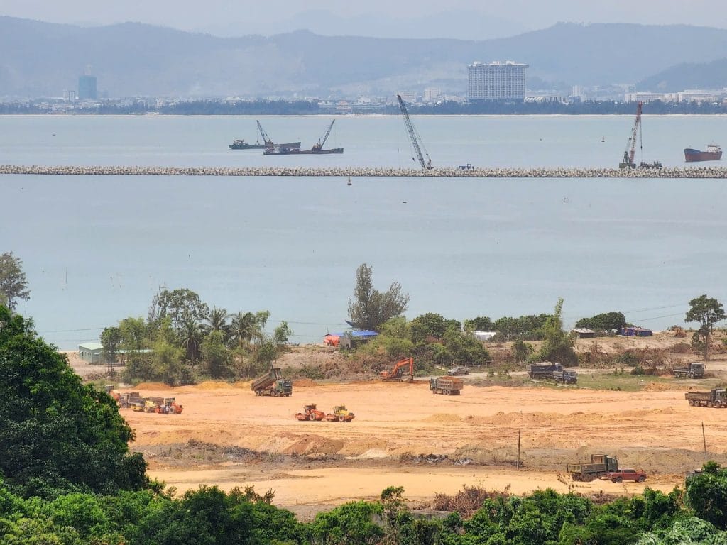 Khu vực ven biển trong dự án Vinhomes Làng Vân đang được san lấp mặt bằng, hướng ra cảng chắn sóng và thành phố Đà Nẵng phía xa.
